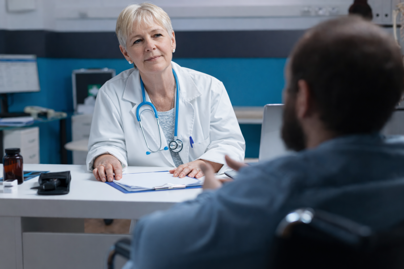 A National Friends team member listening to a patient across a table